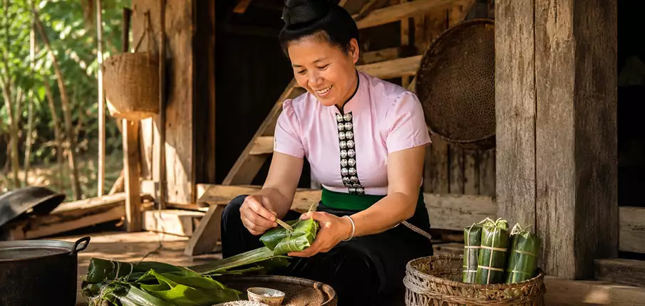 Thai Ethnic Woman Preparing Com Lam in Son La Province, Vietnam Thai ethnic woman preparing traditional Com Lam bamboo rice in Son La Province, northern Vietnam