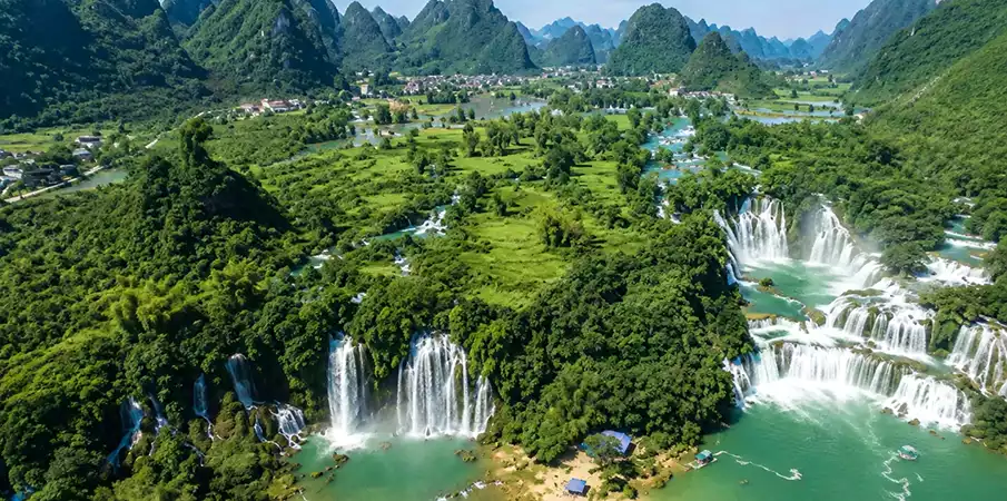 Aerial panorama of Ban Gioc Waterfall surrounded by limestone mountains in Cao Bang, Vietnam