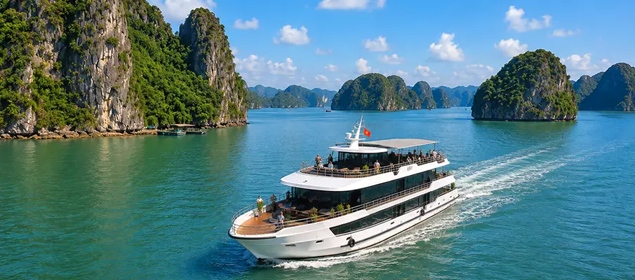 Modern cruise boat sailing through Lan Ha Bay near Cat Ba Island in northern Vietnam
