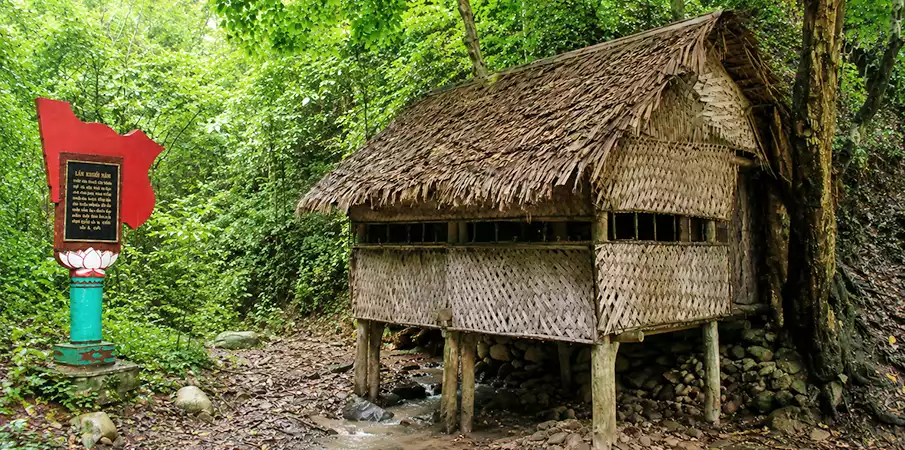 Khuoi Nam Hut surrounded by forest at Pac Bo Historical Site in Cao Bang, Vietnam