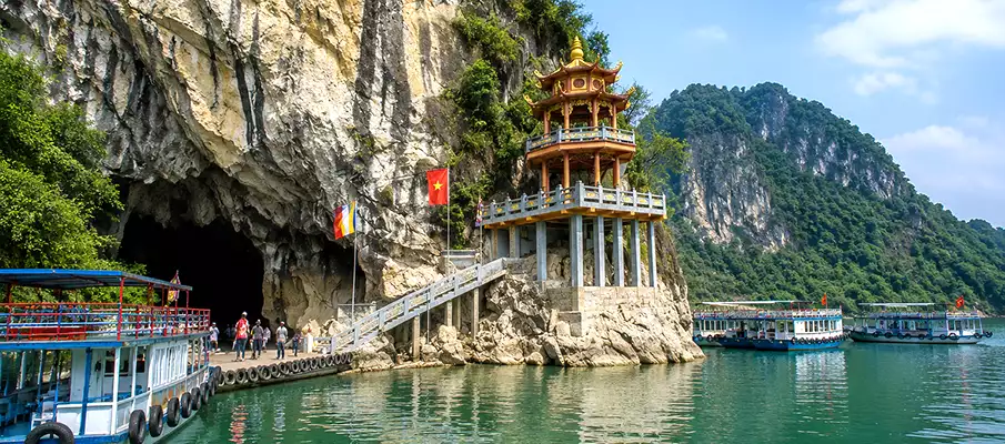 Thac Bo Cave and Pagoda on Hoa Binh Lake, Northern Vietnam Thac Bo Cave entrance and pagoda with tour boats on Hoa Binh Lake in northern Vietnam